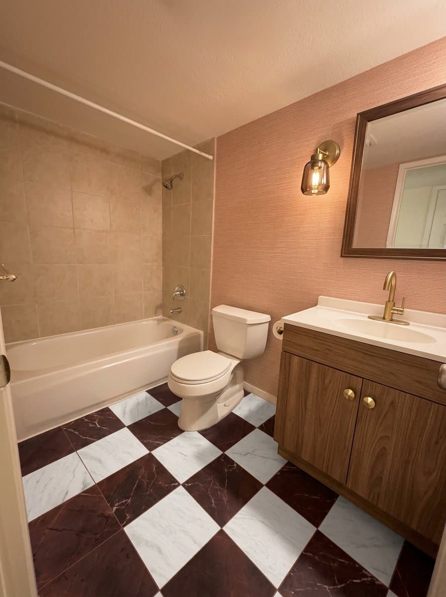 The same bathroom redesigned in the clay and oxblood style.
